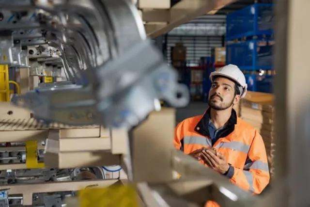 Manufacturing floor or warehouse with products, operator at work