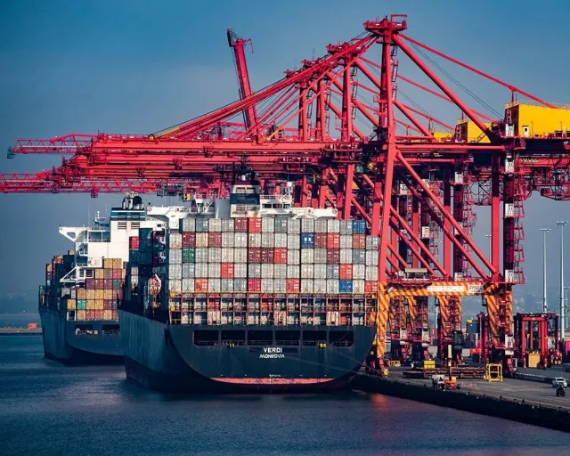 Trucks at a loading dock or containers at port, early morning